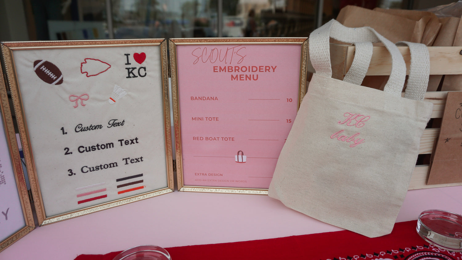 Embroidery menu, custom text, and a tote bag on a table. Kansas City themed Embroidery